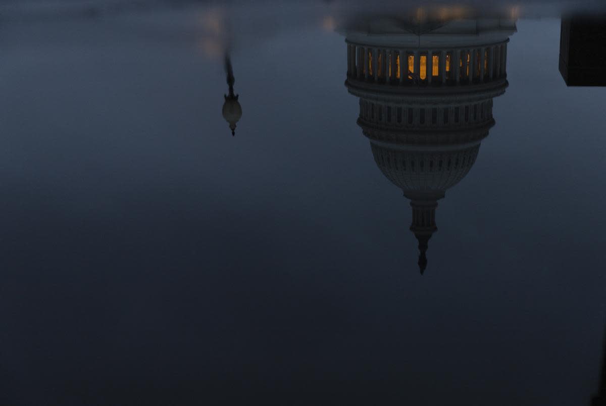 The U.S. Capitol, seen in a reflection, on a cloudy evening Jan. 22, 2023 in Washington D.C.