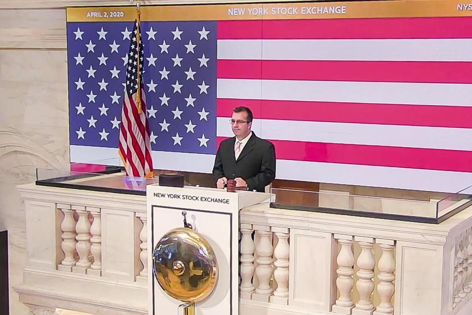 In this photo taken from video provided by the New York Stock Exchange, Robert Glorioso, Chief, Building Engineering Operations, rings the opening bell at the NYSE, Thursday, April 2, 2020. Stocks are wavering between small gains and losses early Thursday after a report showed a record number of Americans lost their jobs last week due to the coronavirus outbreak. (New York Stock Exchange via AP)