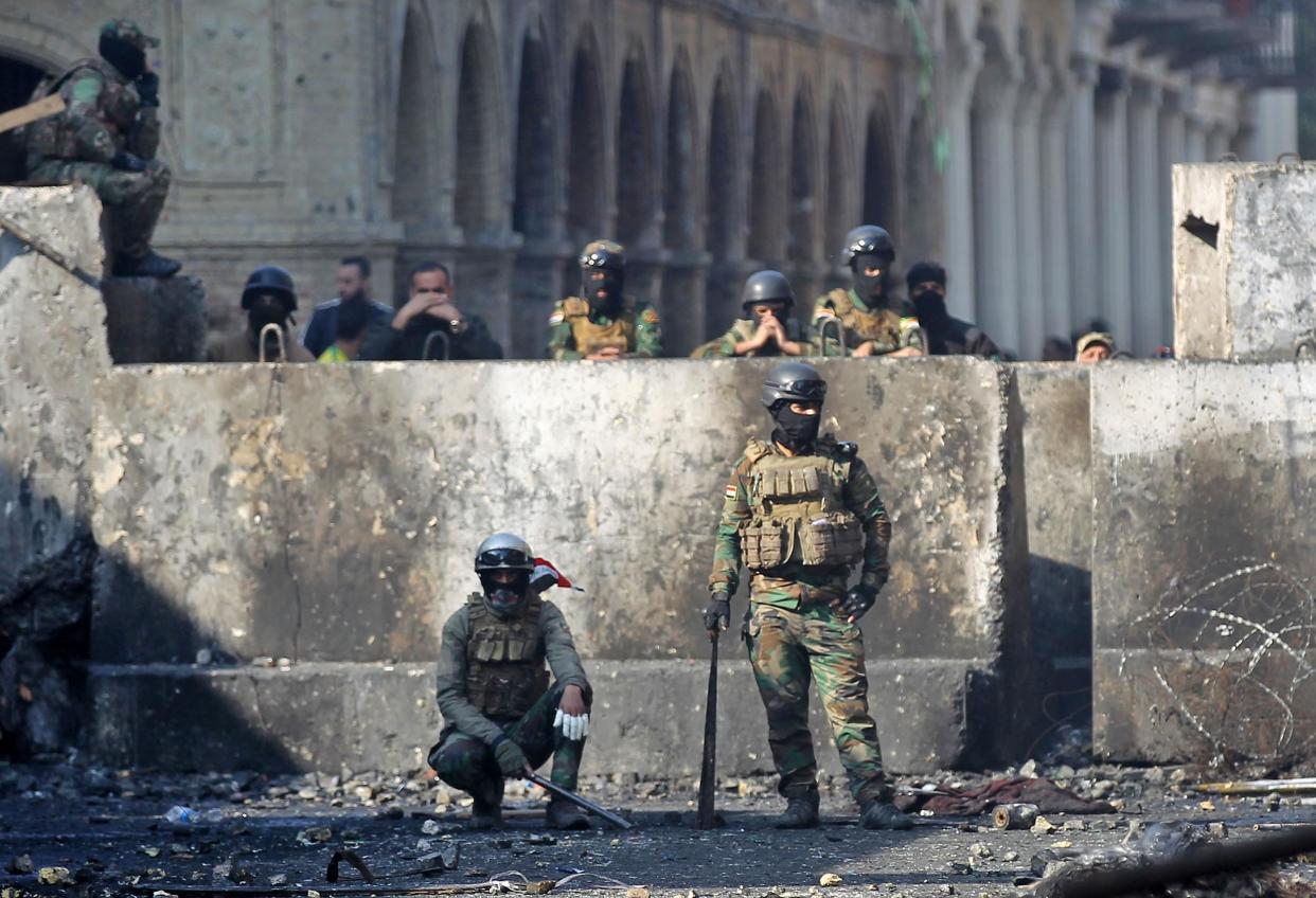 Iraqi security forces gather in front of a concrete barrier on al-Rasheed street in the capital Baghdad: AFP/Getty