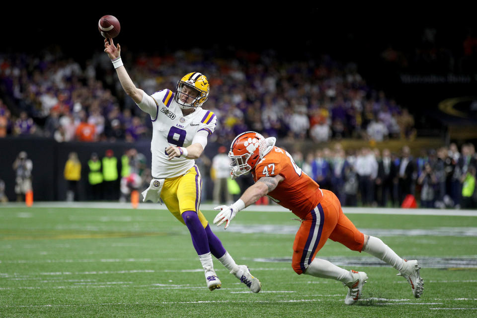 NEW ORLEANS, LOUISIANA - JANUARY 13: Joe Burrow #9 of the LSU Tigers throws the ball under pressure as James Skalski #47 of the Clemson Tigers tries to defend during the College Football Playoff National Championship game at Mercedes Benz Superdome on January 13, 2020 in New Orleans, Louisiana. (Photo by Chris Graythen/Getty Images)