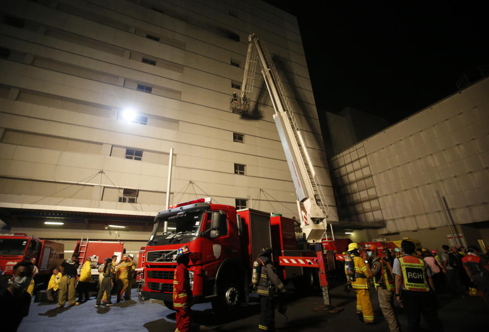 Firefighters work at the scene of a fire outside a mall complex, Wednesday, April 10, 2019, in downtown Bangkok, Thailand. The fire had broken out in the Central World mall complex in Thailand's capital, with reports from emergency services saying it has caused a number of fatalities. (AP Photo/Sakchai Lalit)