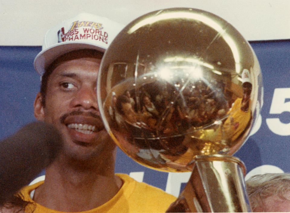 Los Angeles Lakers Kareem Abdul-Jabbar holds a championship trophy as he talks to members of the press after the game 6 championship against the Boston Celtics in Boston, June 9, 1985.  (Photo by Stan Grossfeld/The Boston Globe via Getty Images)