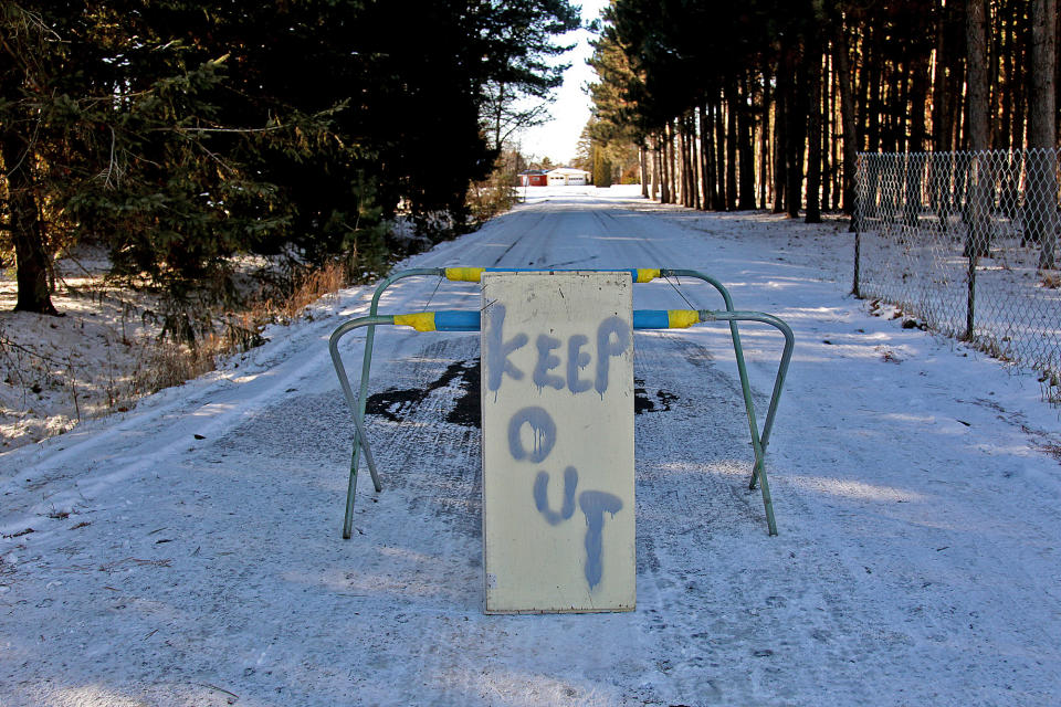 FILE - In this Nov. 26, 2012 file photo, a keep out sign stands at the property of Byron David Smith, in Little Falls, Minn. The Little Falls man who claimed he was defending his home from teens who had been terrorizing him for months goes on trial Monday, April 14, 2014, for their murders. (AP Photo/The Star Tribune, Elizabeth Flores) MANDATORY CREDIT; ST. PAUL PIONEER PRESS OUT; MAGS OUT; TWIN CITIES TV OUT