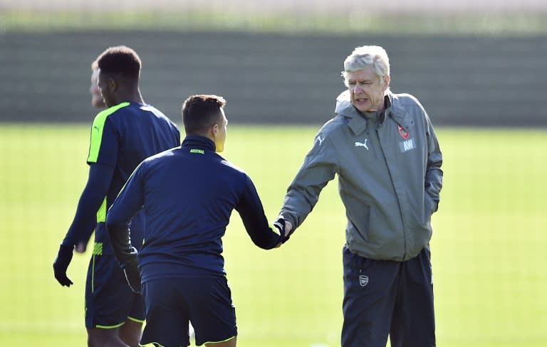 Arsenal manager Arsene Wenger (right) shakes hands with Chilean striker Alexis Sanchez during a training session in London Colney, on March 6, 2017