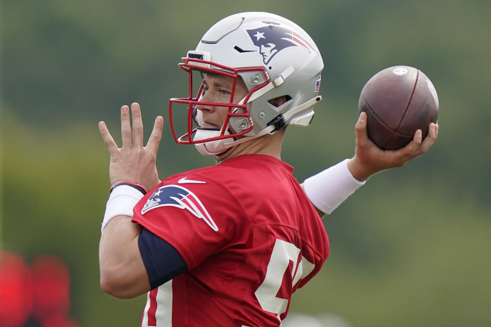 New England Patriots quarterback Mac Jones winds up for a pass during an NFL football practice, Wednesday, Aug. 4, 2021, in Foxborough, Mass. (AP Photo/Steven Senne)