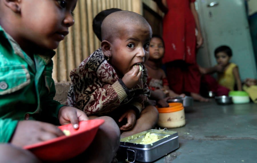 Malnourished children eat a meal at the Apanalay center, an organization working with malnourished children, in Mumbai, India, Wednesday, Jan. 11, 2012. Forty-two percent of children in India younger than 5 are underweight and nearly 60 percent are stunted, according to the Hunger and Malnutrition Survey. Prime Minister Manmohan Singh released the report Tuesday and called child malnutrition the country’s shame. UNICEF’s latest data say one-third of the world’s malnourished children younger than 3 lives in India, a rate worse than sub-Saharan Africa. (AP Photo/Rajanish Kakade)