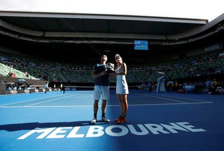 Russia's Elena Vesnina and Brazil's Bruno Soares pose with the mixed doubles trophy after winning their mixed doubles final match at the Australian Open tennis tournament at Melbourne Park, Australia, January 31, 2016. REUTERS/Issei Kato