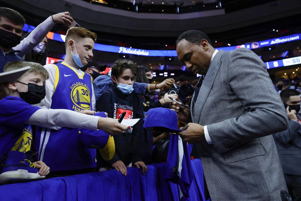 Stephen A. Smith of ESPN signs autographs during a game between the Philadelphia 76ers and the Golden State Warriors at Wells Fargo Center on December 11, 2021 in Philadelphia, Pennsylvania. NOTE TO USER: User expressly acknowledges and agrees that, by downloading and or using this photograph, User is consenting to the terms and conditions of the Getty Images License Agreement.