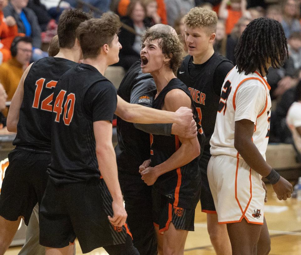 Hoover's Hunter Hershberger, center, celebrates his 3-point shot with teammates that set up the win Tuesday.