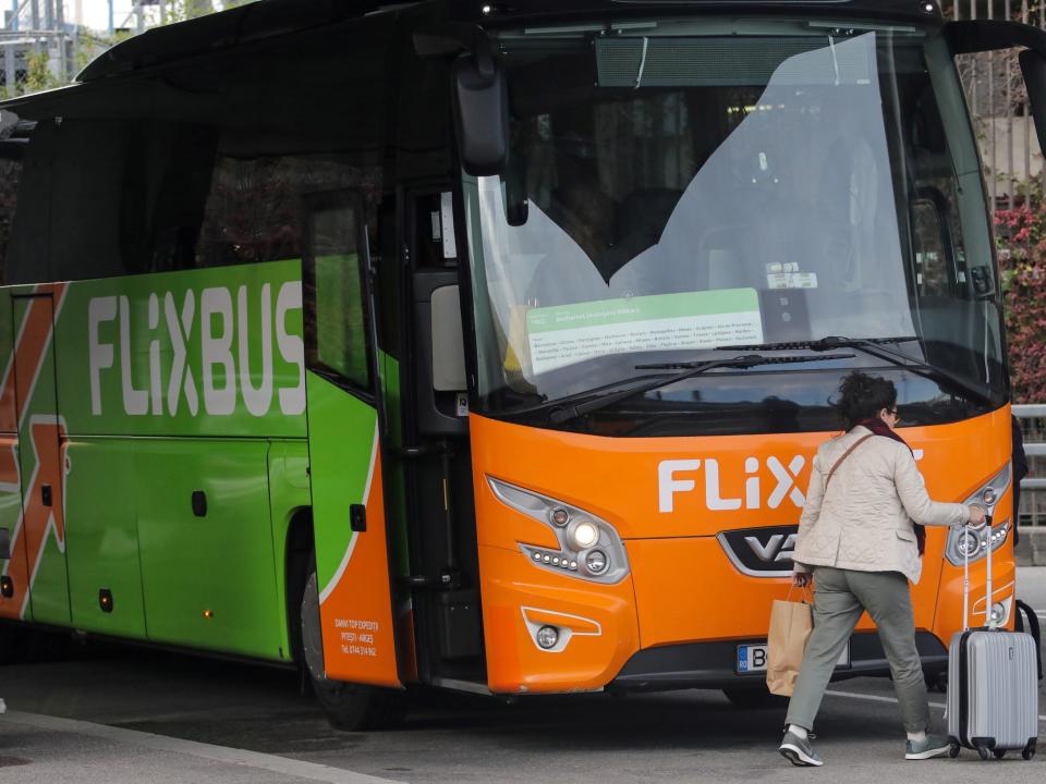 A person walking by a FlixBus at Nice International Airport in 2019.