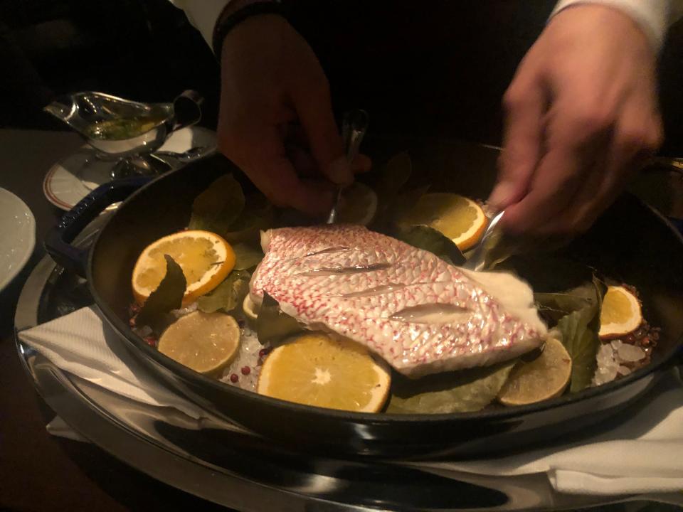 Salt-baked Florida red snapper is served tableside at Carne Mare.