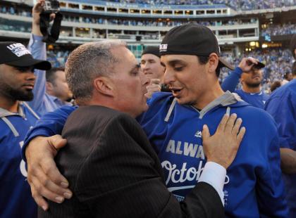 Royals general manager Dayton Moore (left) hugs pitcher Jason Vargas. (USA Today)