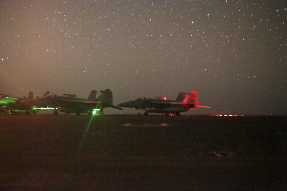 In this photo taken on Sunday, May 26, 2019 and released by the U.S. Navy, F/A-18 Super Hornets sit secured on the flight deck of the Nimitz-class aircraft carrier USS Abraham Lincoln in the Arabian Sea. (Mass Communication Specialist 3rd Class Jeremiah Bartelt/U.S. Navy via AP)