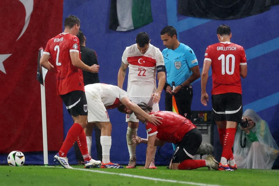 Marcel Sabitzer was attended to by a couple of Turkey players (Getty Images)