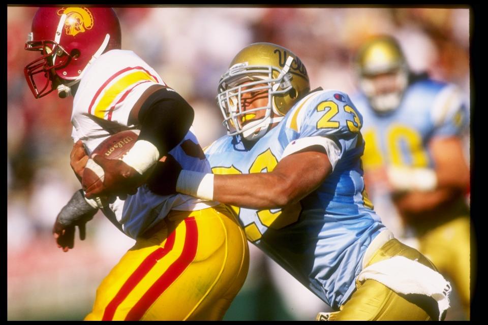 19 Nov 1994: Linebacker Donnie Edwards of the UCLA Bruins tries to make a tackle during a game against the USC Trojans at the Rose Bowl in Pasadena, California. UCLA won the game 31-19. Mandatory Credit: Mike Powell /Allsport