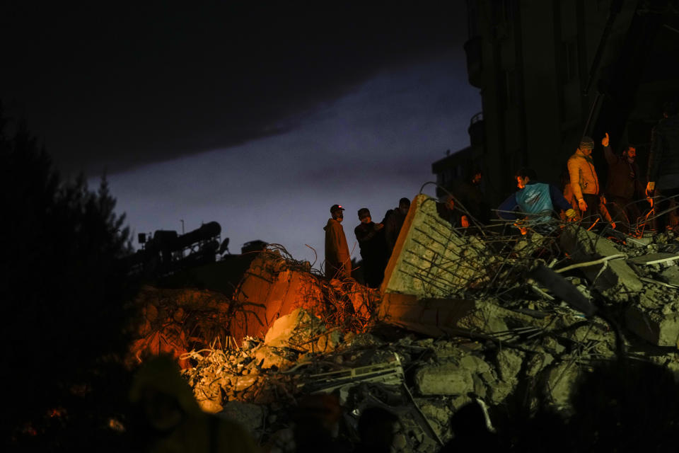 Emergency team members search for people in a destroyed building in Adana, Turkey, Tuesday, Feb. 7, 2023. Rescuers raced Tuesday to find survivors in the rubble of thousands of buildings brought down by a powerful earthquake and multiple aftershocks that struck eastern Turkey and neighbouring Syria. (AP Photo/Francisco Seco)