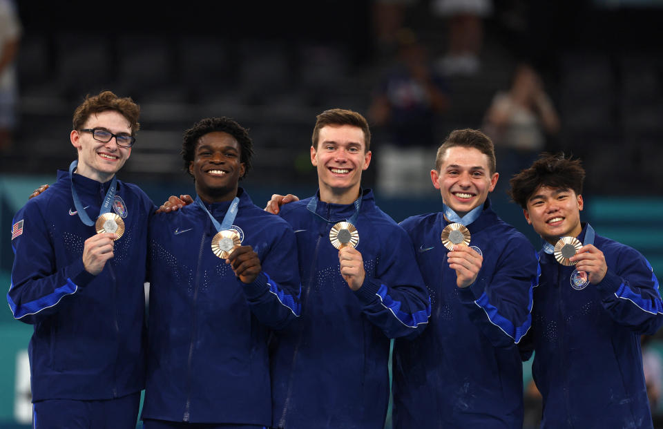 Paris 2024 Olympics - Artistic Gymnastics - Men's Team Victory Ceremony - Bercy Arena, Paris, France - July 29, 2024. Bronze medallist's Stephen Nedoroscik, Paul Juda, Brody Malone, Frederick Richard and Asher Hong of United States celebrate on the podium with their medals. REUTERS/Hannah Mckay