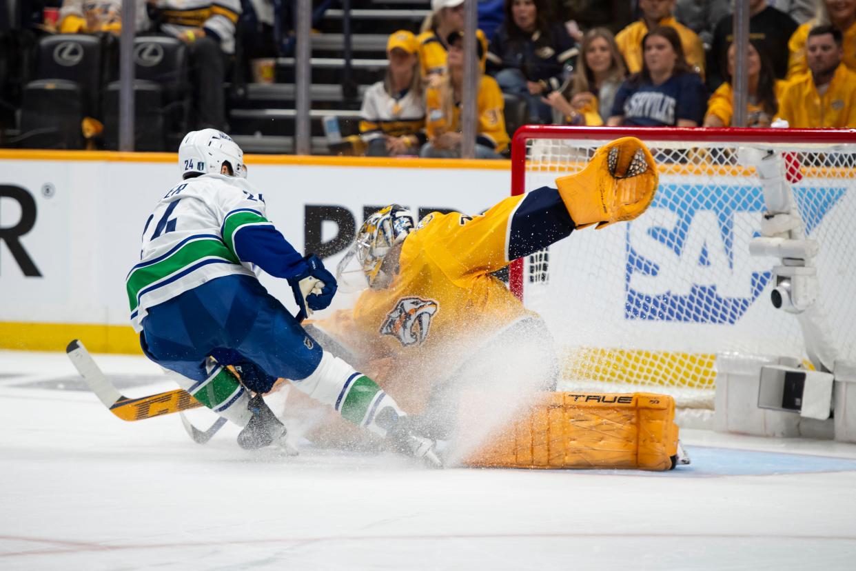 Nashville Predators goaltender Juuse Saros (74) makes a save on Vancouver Canucks center Pius Suter (24) during the second period of Game 6.