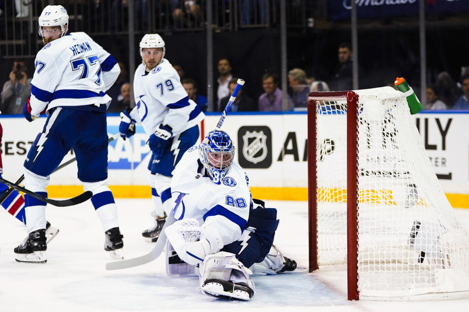 Tampa Bay Lightning's Victor Hedman (77), Ross Colton (79) and goaltender Andrei Vasilevskiy (88) watch the puck shot by New York Rangers' Filip Chytil for a goal during the second period of Game 1 of the NHL hockey Stanley Cup playoffs Eastern Conference finals Wednesday, June 1, 2022, in New York. (AP Photo/Frank Franklin II)