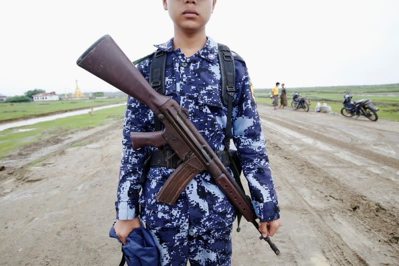 FILE PHOTO: Myanmar police officer poses for a photograph in Maungdaw, Rakhine