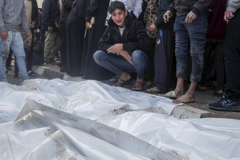 Palestinians mourn their relatives killed in the Israeli bombardment of the Gaza Strip, in Deir al Balah, Gaza Strip, on Monday, Dec. 25, 2023. (AP Photo/Adel Hana)