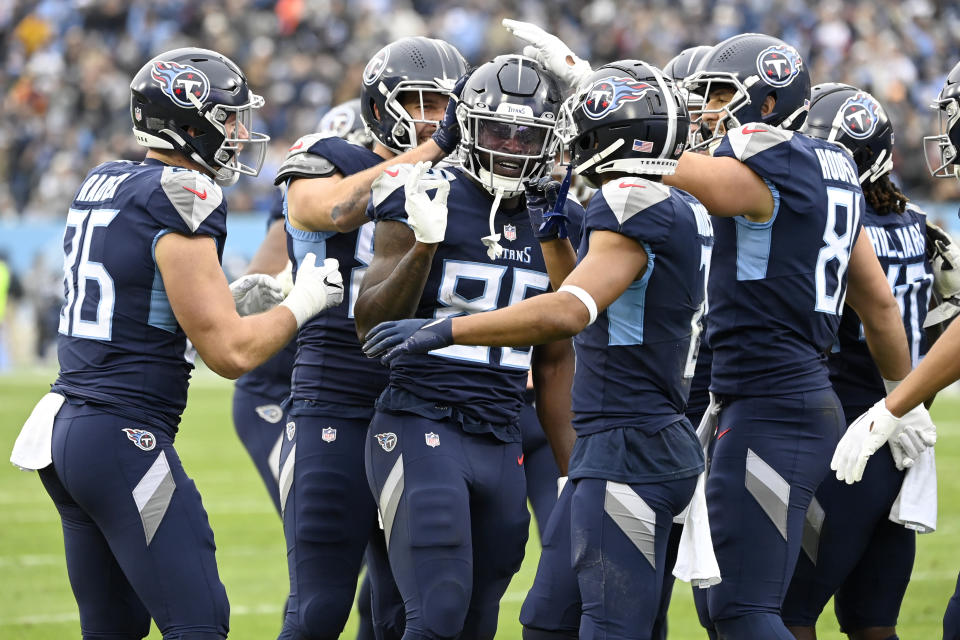 Tennessee Titans tight end Chigoziem Okonkwo (85) is congratulated by teammates after scoring during the first half of an NFL football game against the Jacksonville Jaguars Sunday, Dec. 11, 2022, in Nashville, Tenn. (AP Photo/Mark Zaleski)