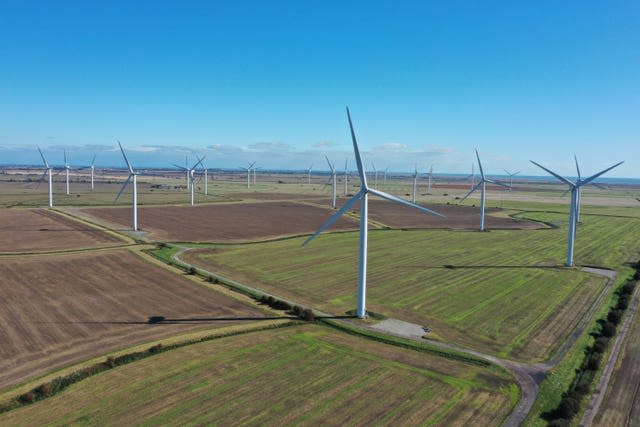 Wind turbines standing among agricultural fields