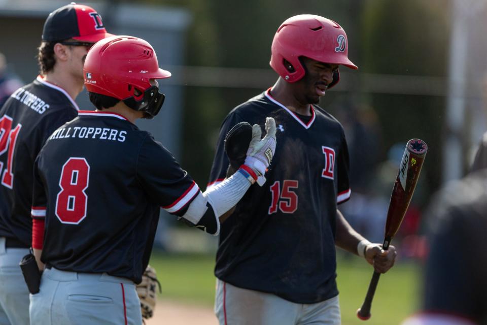 Teammates high-five Alexis Montilla (15) after scoring a run during a recent game against Somerset Berkley.