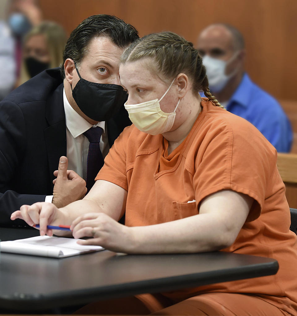 JoAnn Cunningham listens to her public defender, Angelo Mourelatos, during her sentencing hearing Thursday, July 16, 2020, in Woodstock, Ill. Cunningham pled guilty in December to killing her five-year-old son Andrew "A.J." Freund in April 2019 in her Crystal Lake home. (John Starks/Daily Herald via AP, Pool)