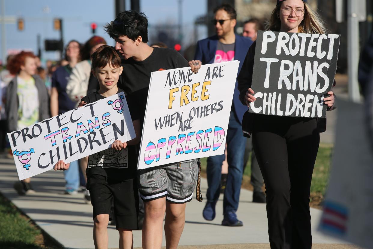 Protesters march at the Statehouse Friday to urge the Kansas Legislature against passing anti-transgender legislation.