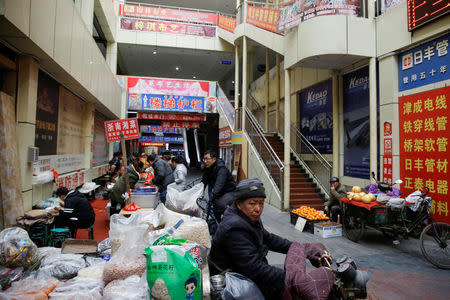 People work in a market for building supplies where traders say business is down due to falling demand and supply shortages in Shijiazhuang, Hebei province, China, December 6, 2017. REUTERS/Thomas Peter