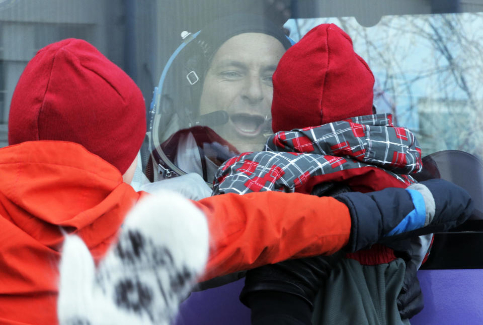 CSA astronaut David Saint Jacques, member of the main crew to the International Space Station (ISS), interacts with his children from a bus prior to the launch of Soyuz-FG rocket at the Russian leased Baikonur cosmodrome, Kazakhstan, Monday, Dec. 3, 2018. (AP Photo/Dmitri Lovetsky, Pool)