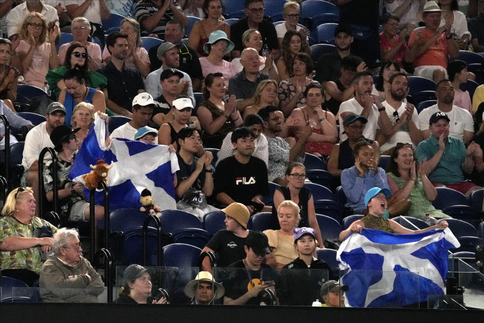 Supporters of Andy Murray of Britain react his first round match against Matteo Berrettini of Italy at the Australian Open tennis championship in Melbourne, Australia, Tuesday, Jan. 17, 2023. (AP Photo/Aaron Favila)