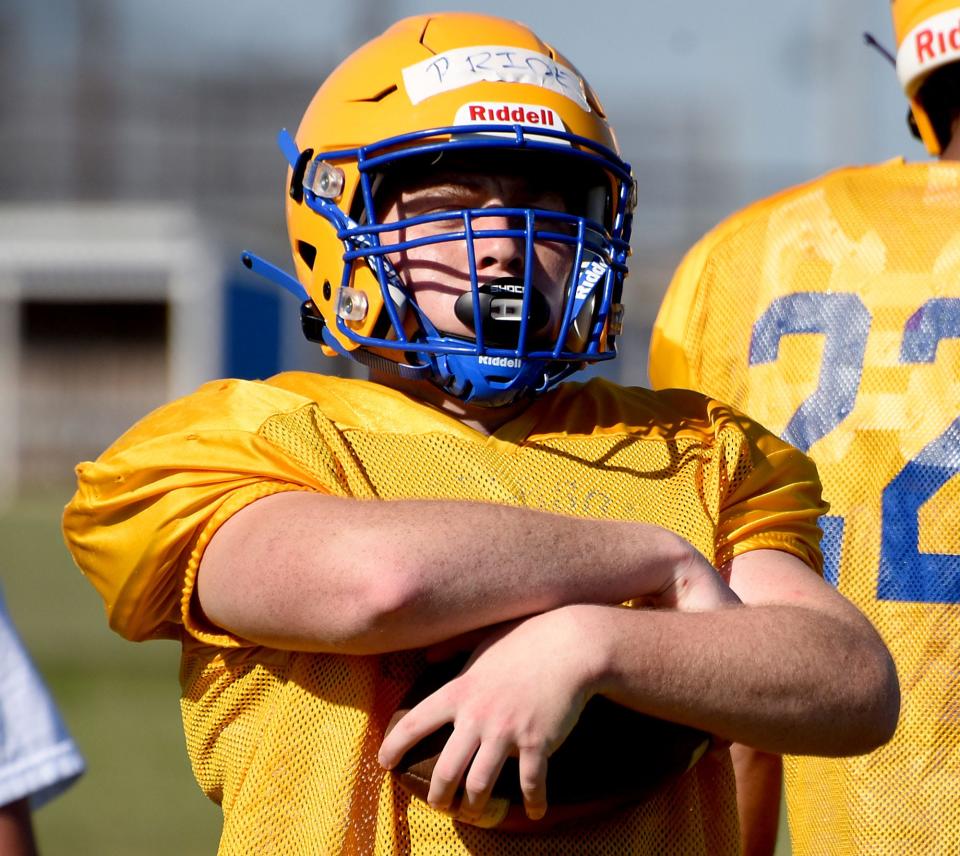 Jefferson back Caden Pridmore wraps up the football while running through offensive drills during practice.
(Photo: Tom Hawley, The Monroe News)