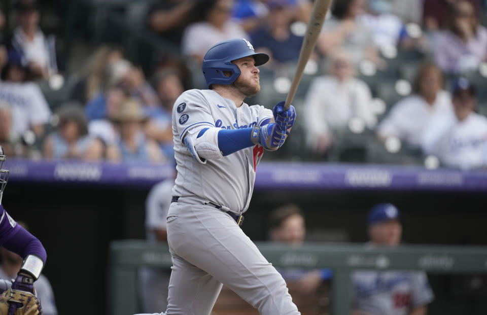 Los Angeles Dodgers' Max Muncy follows the flight of his two-run home run off Colorado Rockies relief pitcher Lucas Gilbreath in the 10th inning of a baseball game Thursday, Sept. 23, 2021, in Denver. (AP Photo/David Zalubowski)