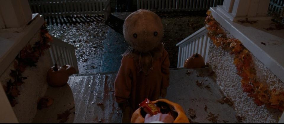 Boy trick or treating in a burlap mask