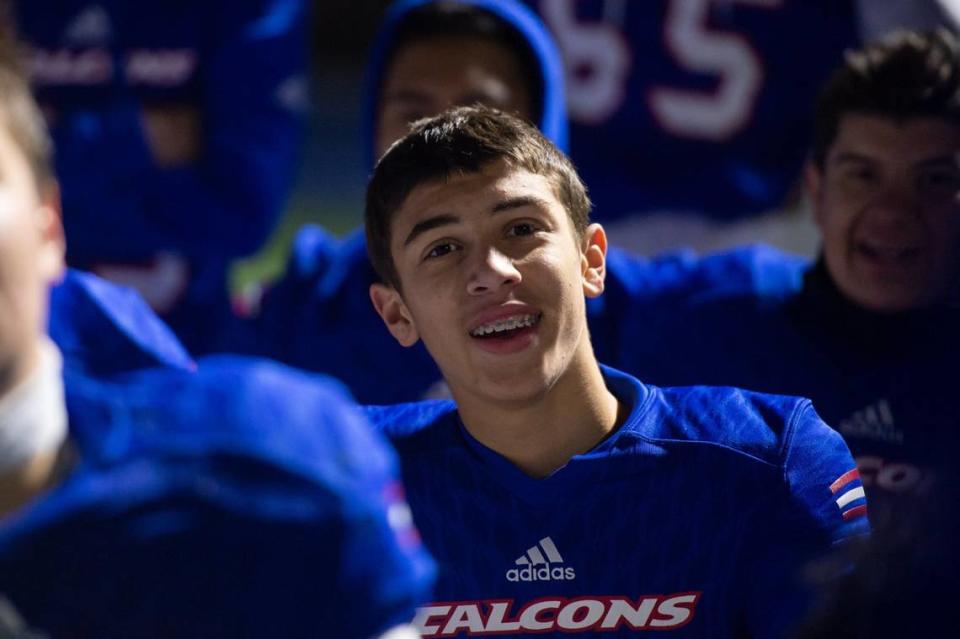 Christian Brothers Falcons freshman quarterback Deakon Holden (15) listens to Christian Brothers Falcons coach Larry Morla after the CIF Sac-Joaquin division III semifinals playoff game Friday, Nov. 18, 2022, at Christian Brothers High School in Sacramento. Holden played in the second half and had 50 passing yards. The Falcons won 20-14.