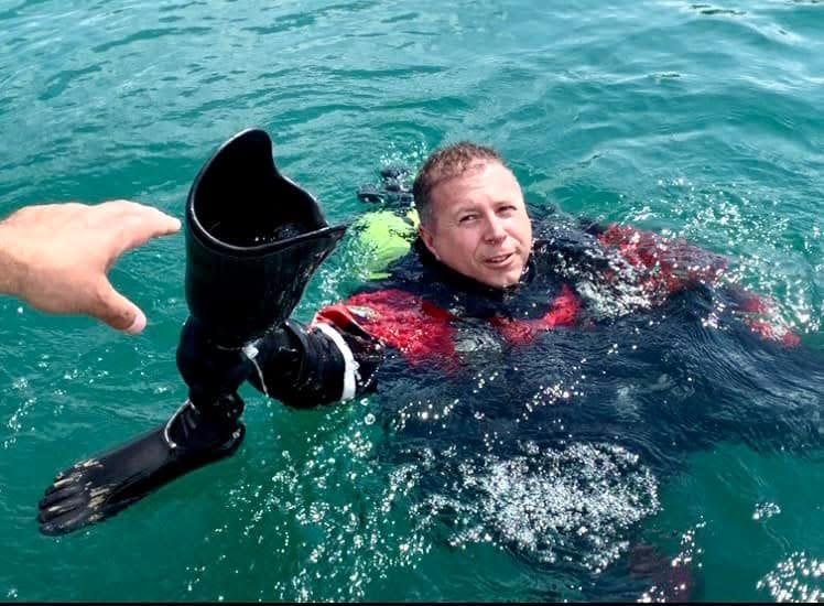 Oakland County Sheriff's Deputy Justin Wiegand recovers a prosthetic leg Monday from Sunrise Lake in Milford Township.