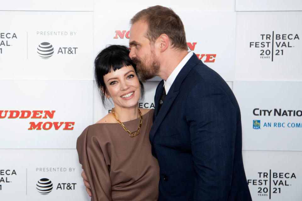 on the red carpet, David kisses Lilly's temple