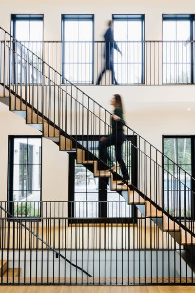 The dramatic stair with a two-story backdrop of Marvin Signature Ultimate Casement Narrow Frame windows is a focal point of the home—and the film. 