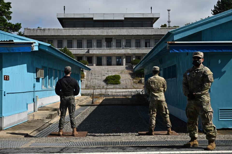 Soldiers stand guard before North Korea's Panmon Hall and the military demarcation line separating North and South Korea (AFP via Getty Images)