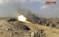 FILE - This file frame grab from a video released on Nov. 2, 2017 by the Syrian official news agency SANA shows a Syrian army tank firing during a battle against Islamic State militants in Deir el-Zour, Syria. The Islamic State group seemed largely defeated last year, with the loss of its territory, the killing of its founder in a U.S. raid and an unprecedented crackdown on its social media propaganda machine but tensions between the U.S. and Iran in the region provide a comeback opportunity for the extremist group. (SANA via AP, File)