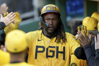 Pittsburgh Pirates' Oneil Cruz celebrates in the dugout after scoring during the first inning of a baseball game against the Chicago Cubs, Friday, May 10, 2024, in Pittsburgh. (AP Photo/Matt Freed)