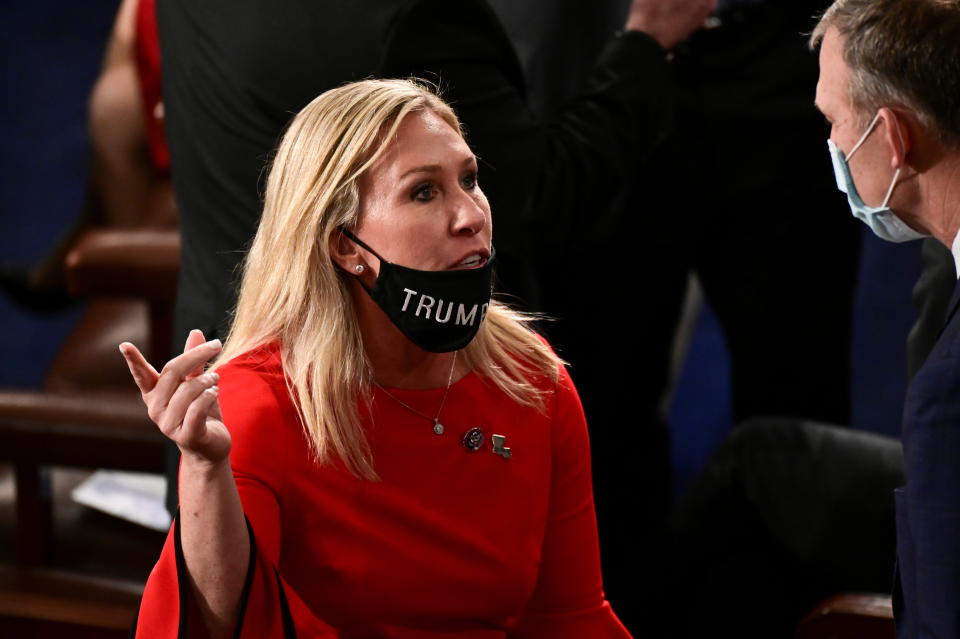 Rep. Marjorie Taylor Greene (R-Ga.), wearing a mask that reads "Trump won," speaks with a colleague on Jan. 3. The congresswoman has professed her support for many conspiracy theories, including that the 2020 election was stolen from Donald Trump.  (Photo: Bill O'Leary/Pool/via REUTERS)