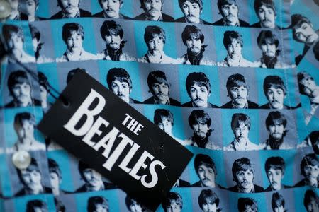 The faces of the four Beatles appear on the fabric of a shirt for sale in a shop in Liverpool northern England, March 2, 2015. REUTERS/Phil Noble