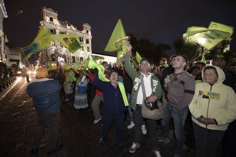 Supporters of Ecuadorean President Rafael Correa celebrate his re-election, outside the Carondelet presidential palace in Quito on February 17, 2013