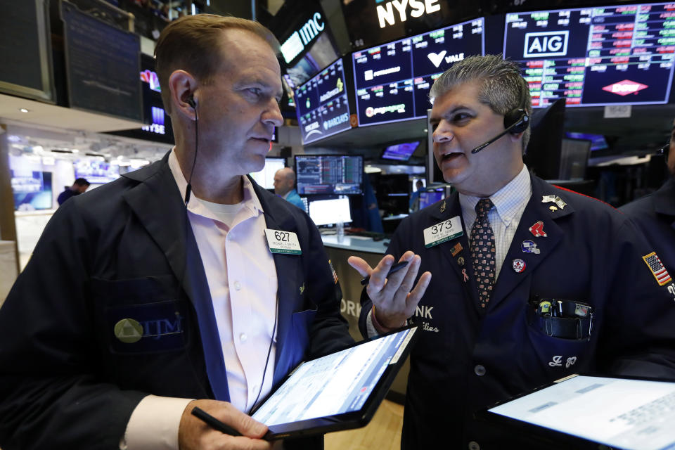 Traders Michael Smyth, left, and John Panin confer on the floor of the New York Stock Exchange, Friday, July 19, 2019. U.S. stocks moved broadly higher in early trading on Wall Street Friday and chipped away at the week's losses. (AP Photo/Richard Drew)