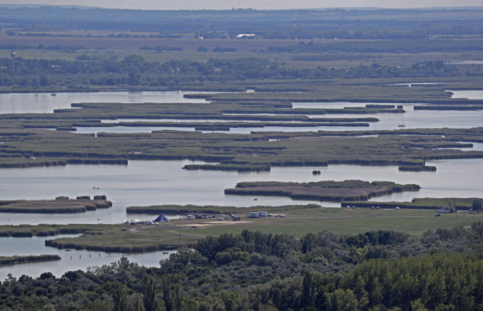 General view of Lake Velence in Agard, Hungary, Sunday, Aug. 8, 2021. Activists and environmental experts in Hungary say the effects of climate change and insufficient infrastructure are colliding to threaten the country’s third largest natural lake with an economic and ecological crisis. Lake Velence has lost nearly half of its water in the last two years as hot, dry summers have led to increased evaporation and deteriorating water quality. (AP Photo/Laszlo Balogh)