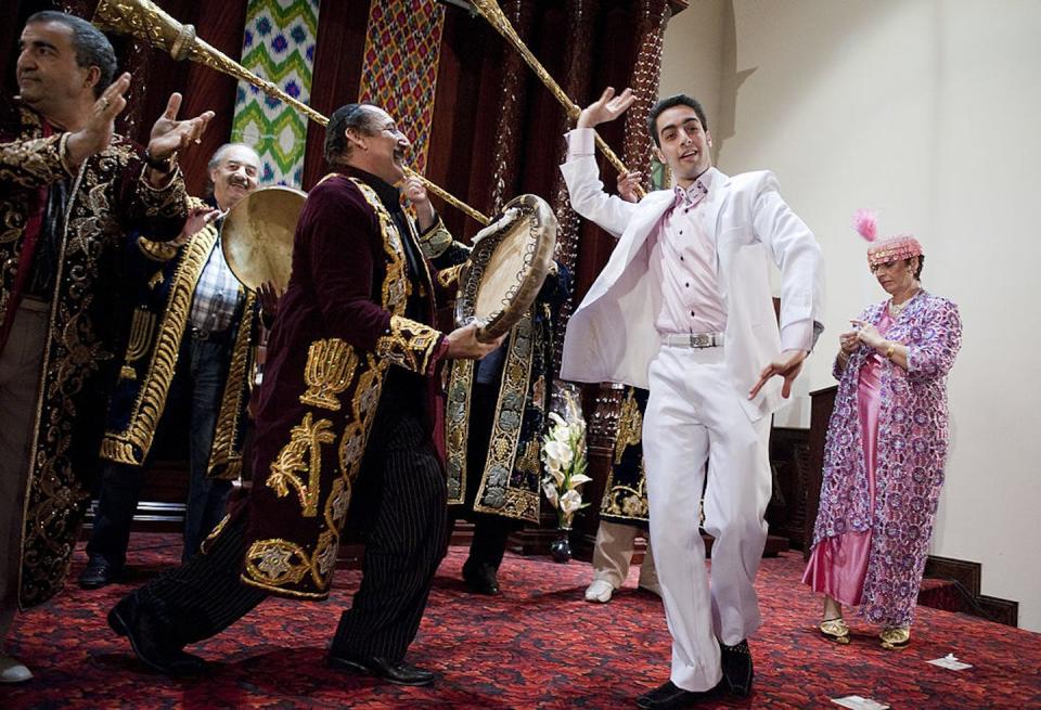 Dancers perform during a celebration of the Ohr Natan congregation of Bukharan Jews in the Rego Park section of Queens in New York in 2011. <a href="https://www.gettyimages.com/detail/news-photo/dancers-perform-during-a-celebration-of-the-ohr-natan-news-photo/123136917?adppopup=true" rel="nofollow noopener" target="_blank" data-ylk="slk:Tom Williams/Roll Call via Getty Images;elm:context_link;itc:0;sec:content-canvas" class="link ">Tom Williams/Roll Call via Getty Images</a>
