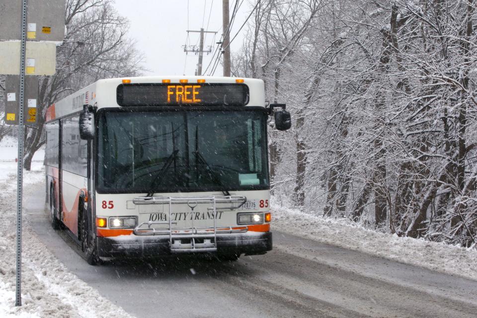 A bus drives along Greenwood Drive in the snow Tuesday, Jan. 9, 2024 in Iowa City, Iowa.